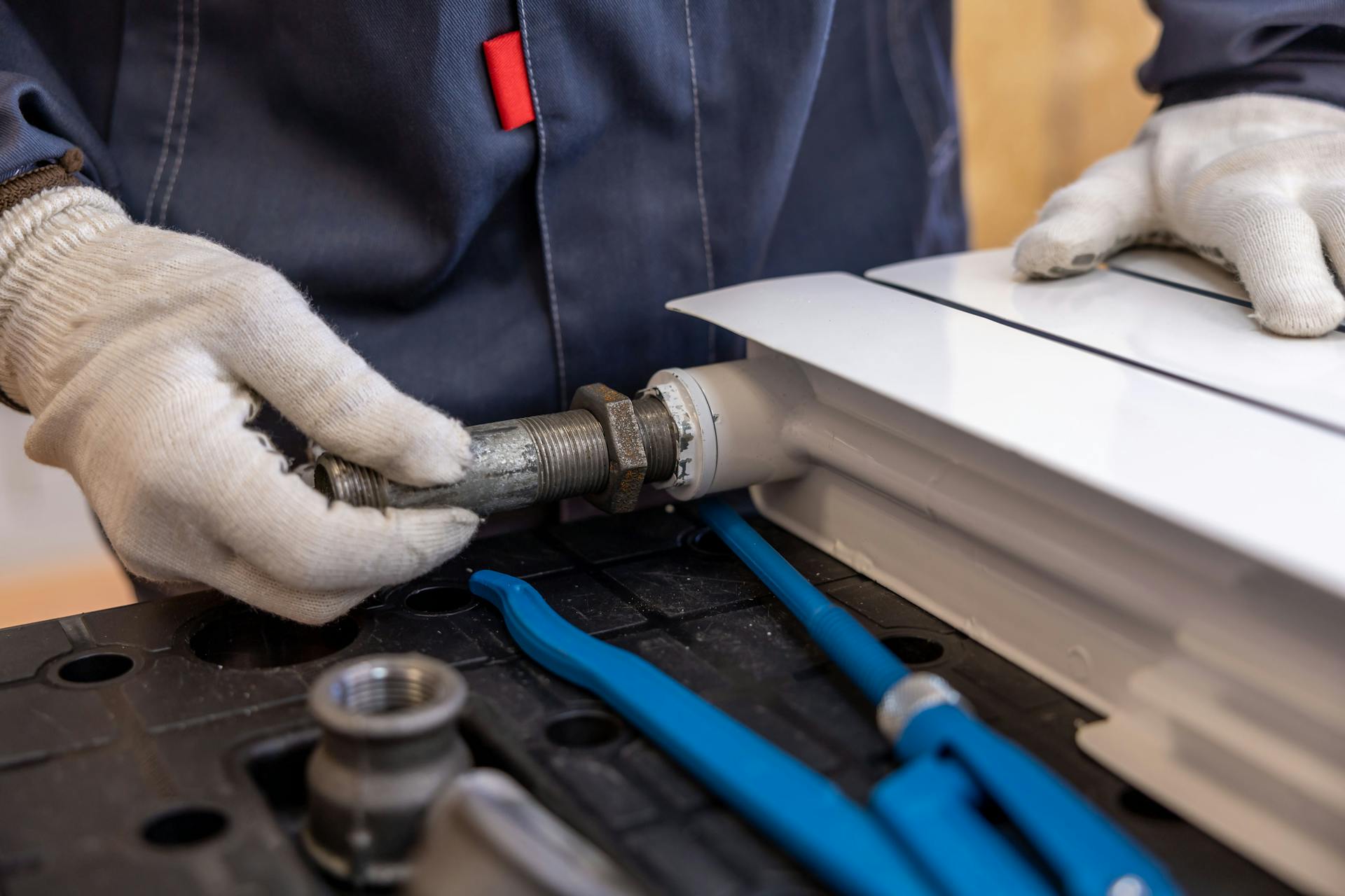 Close up image of a plumber carrying out work