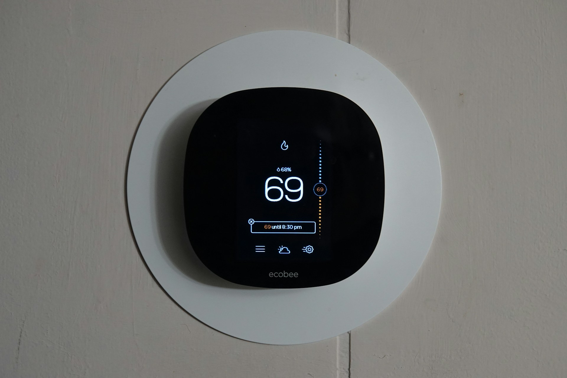 Smart home control panel on wall showing lighting and heating controls with installation costs